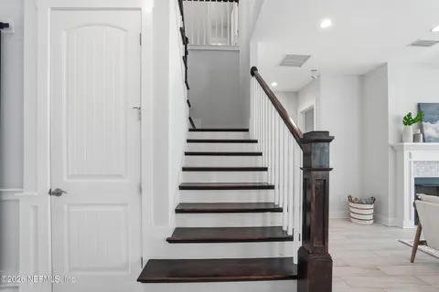 a view of swimming pool with palm trees
