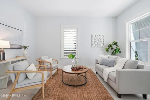 a kitchen with granite countertop white cabinets stainless steel appliances and a counter space
