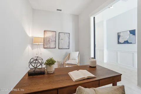 a view of a dining room with furniture wooden floor and chandelier