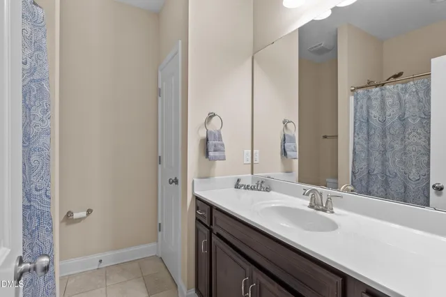 a bedroom with a bed and a ceiling fan