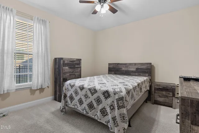 a living room with furniture a fireplace and a chandelier
