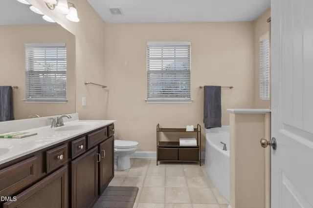 a bathroom with a bathtub and a window
