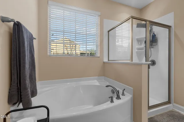 a living room with furniture a fireplace and a large window