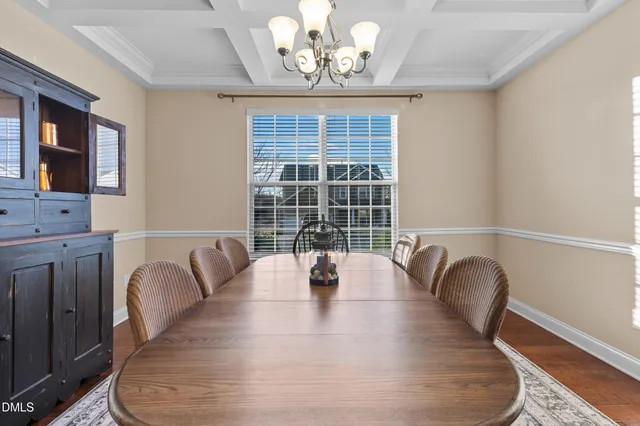 a kitchen with stainless steel appliances granite countertop wooden floors stove sink and cabinets