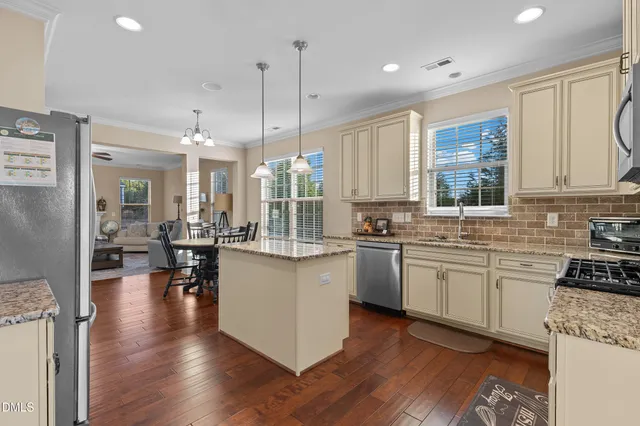 a kitchen with granite countertop cabinets stainless steel appliances and a sink