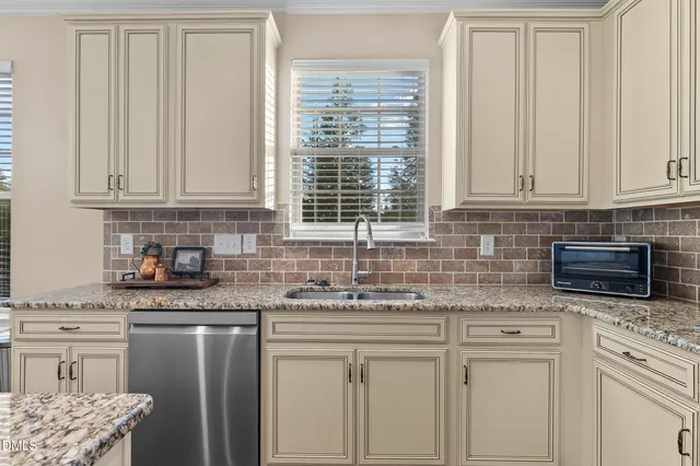 a kitchen with a stove a sink and a refrigerator