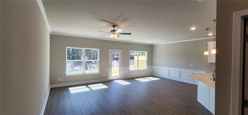 1476 Fern Ridge Lane Norcross, GA 30093 - Photo 5 of 19 a view of an empty room with a window and wooden floor