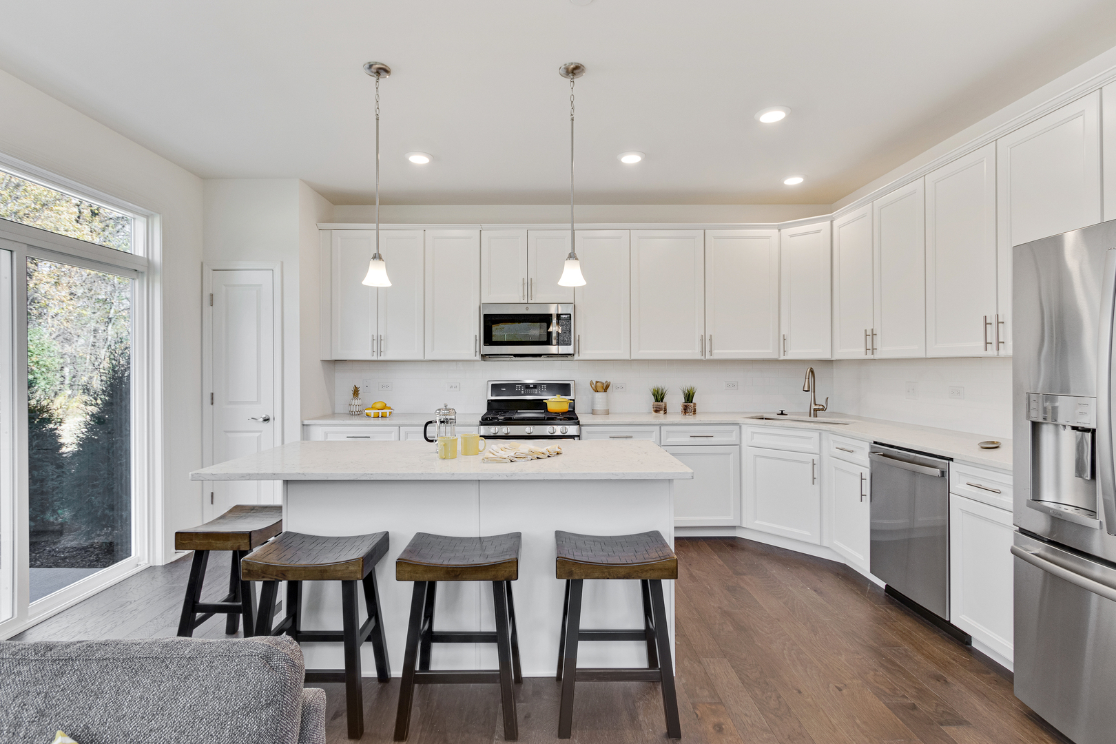 2017 Stuttle Road Batavia, IL 60510 - Photo 9 of 23 a kitchen with kitchen island granite countertop a table chairs microwave and cabinets