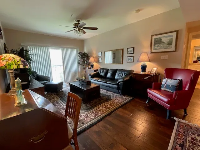 a living room with furniture and a wooden floor