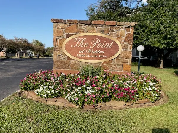 a sign that is in front of flowers