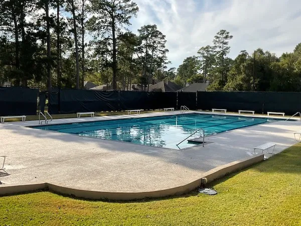 a view of a swimming pool with an outdoor seating