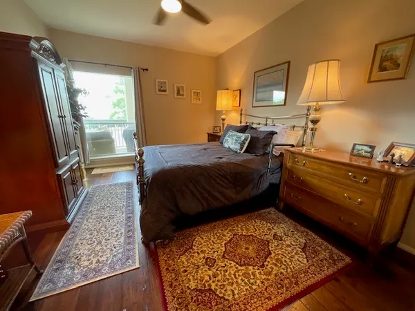 a bathroom with a granite countertop sink a toilet a mirror and shower
