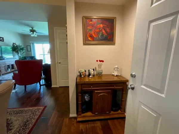 a view of a hallway with wooden floor and a window