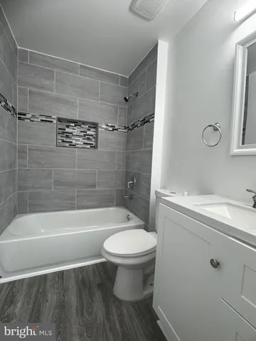 a bathroom with a bathtub toilet and a shower