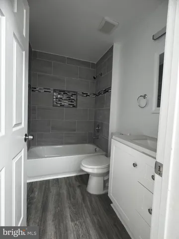 a kitchen with granite countertop a refrigerator stove and sink