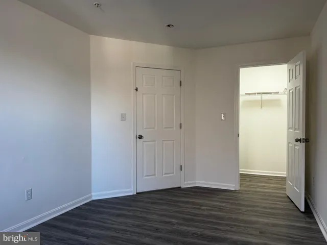 a view of wooden floor and windows in a room