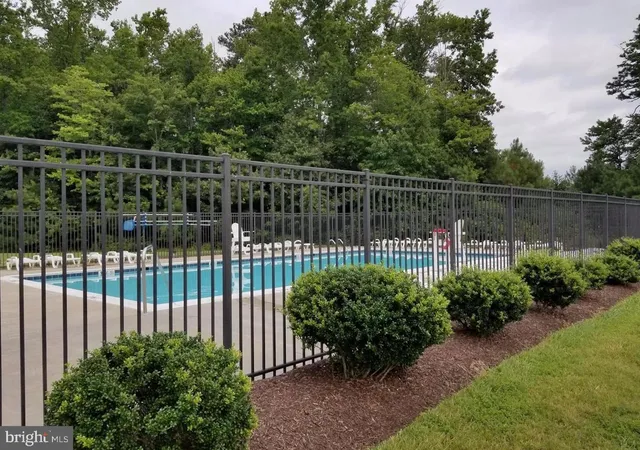 a view of a house with a big yard and large trees