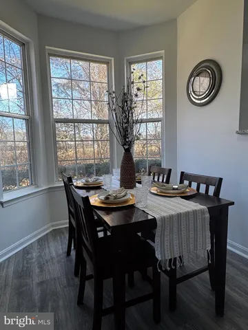 a view of a dining room with a table and chairs