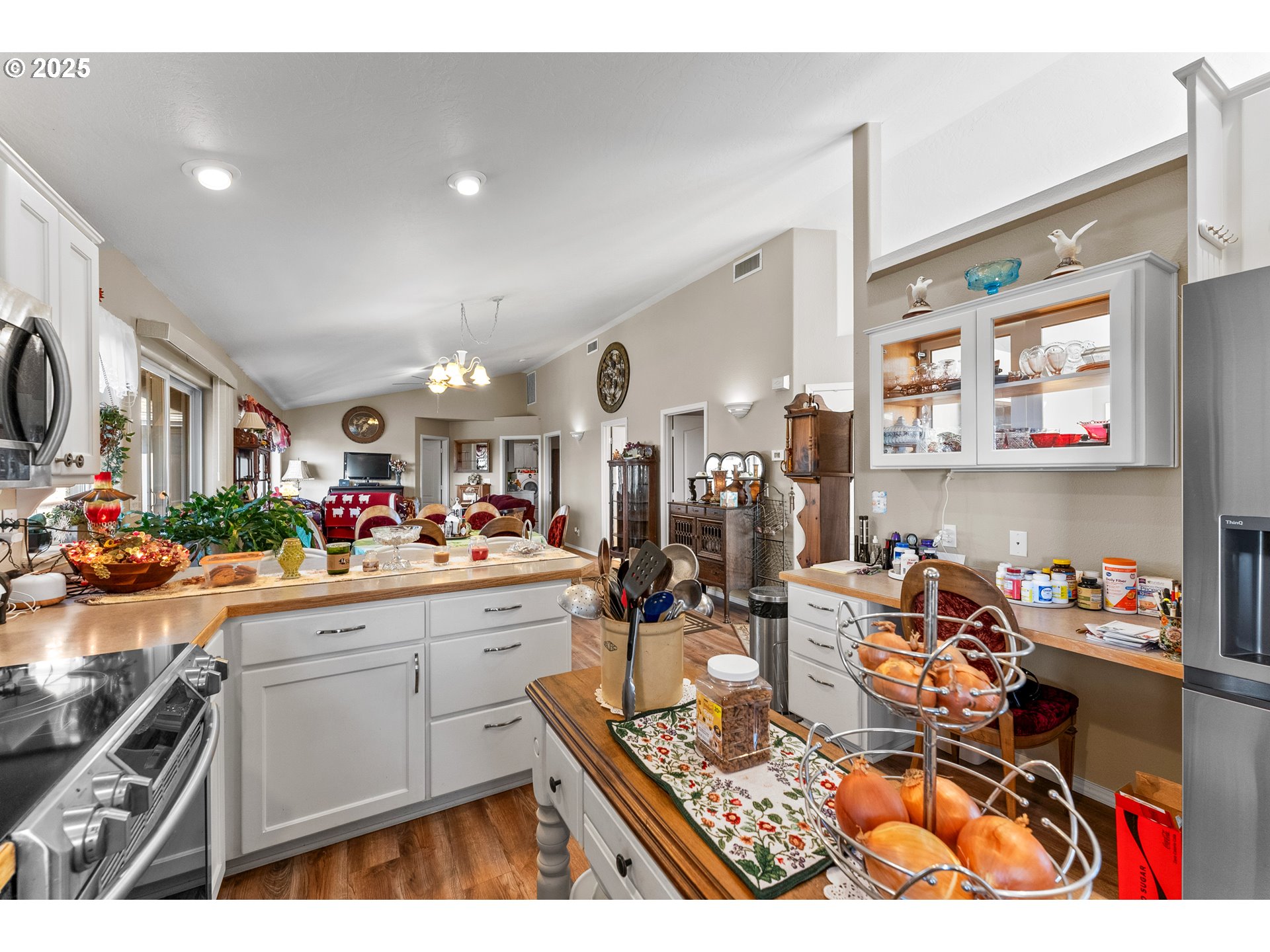 838 Marina Heights Road Brookings, OR 97415 - Photo 24 of 47 a very nice looking open kitchen with stainless steel appliances kitchen island granite countertop a sink and cabinets