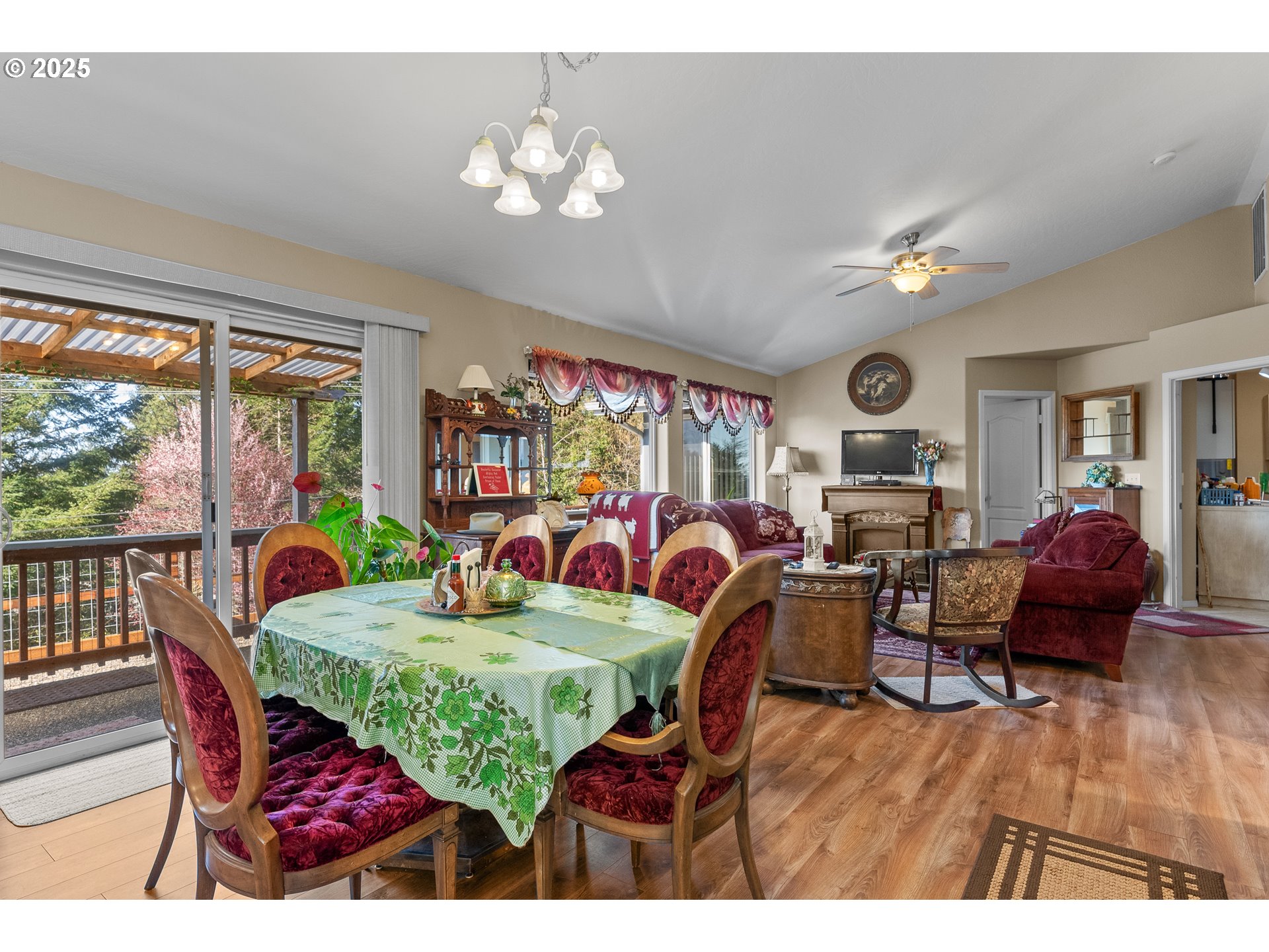 838 Marina Heights Road Brookings, OR 97415 - Photo 29 of 47 a dining room with furniture a rug a potted plant and a chandelier