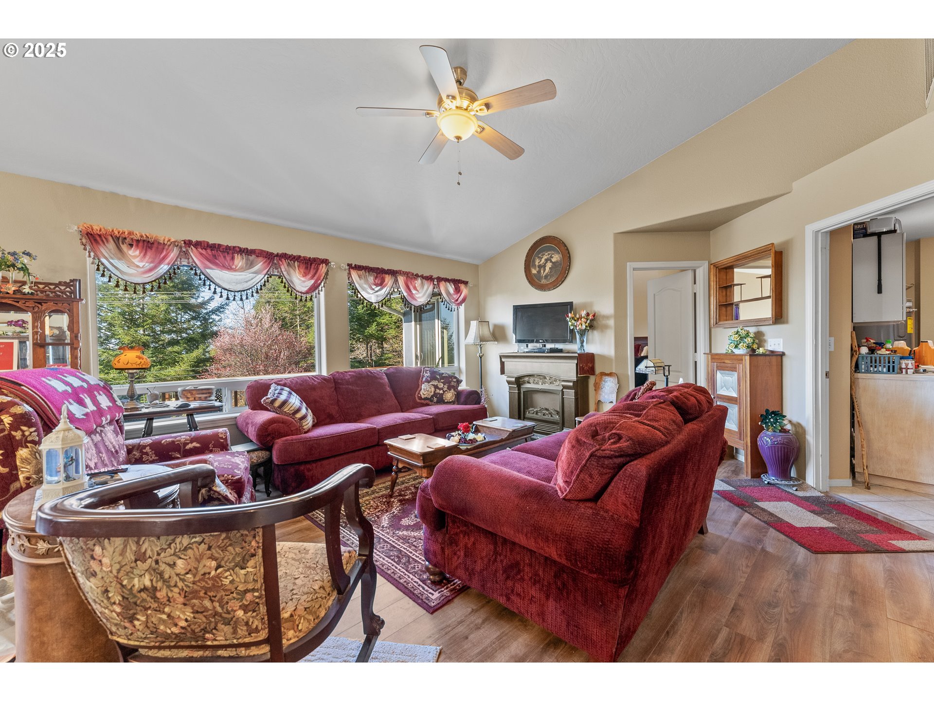 838 Marina Heights Road Brookings, OR 97415 - Photo 30 of 47 a living room with furniture a clock and a large window