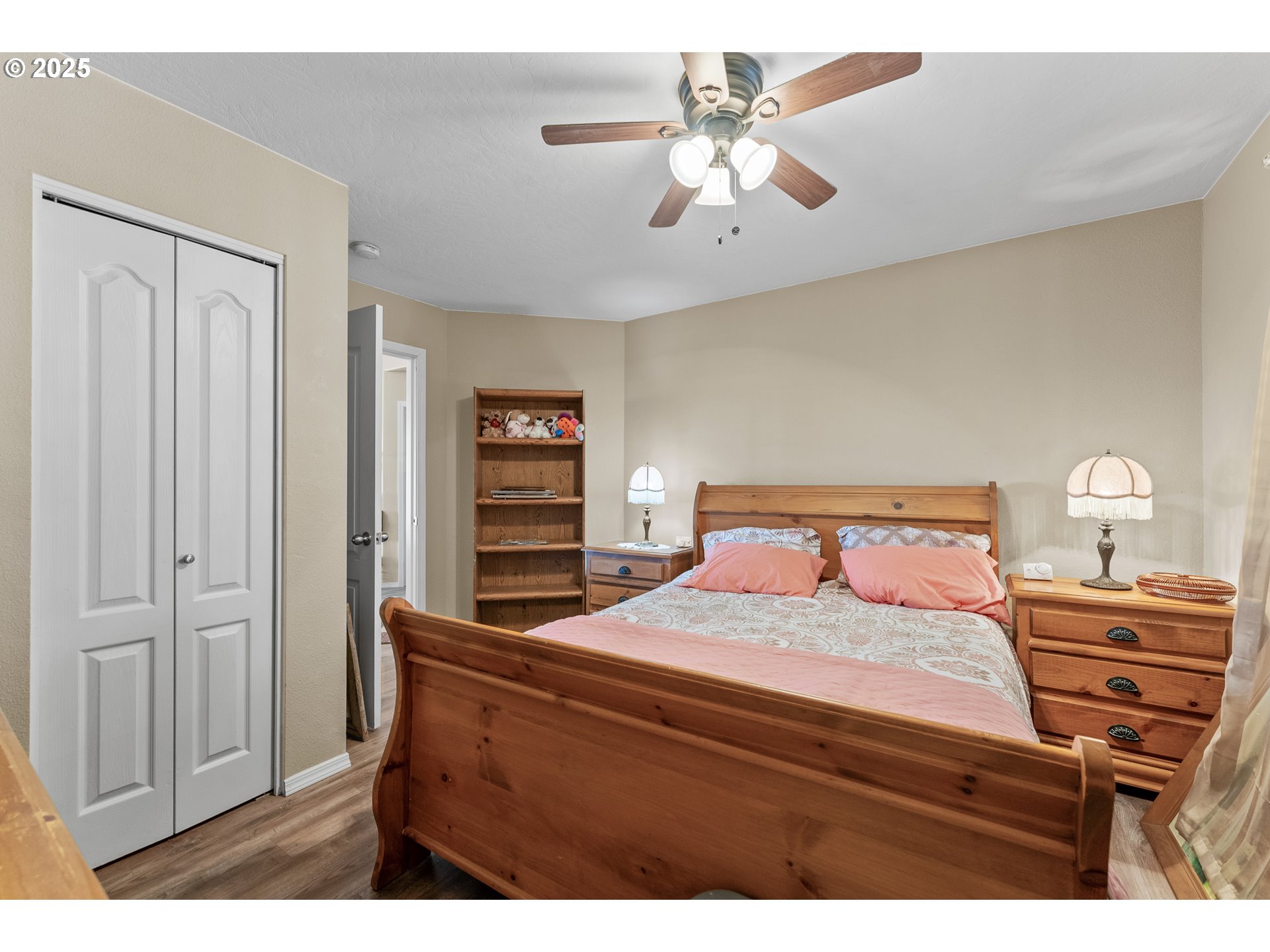 838 Marina Heights Road Brookings, OR 97415 - Photo 32 of 47 a bedroom with a bed and a chandelier