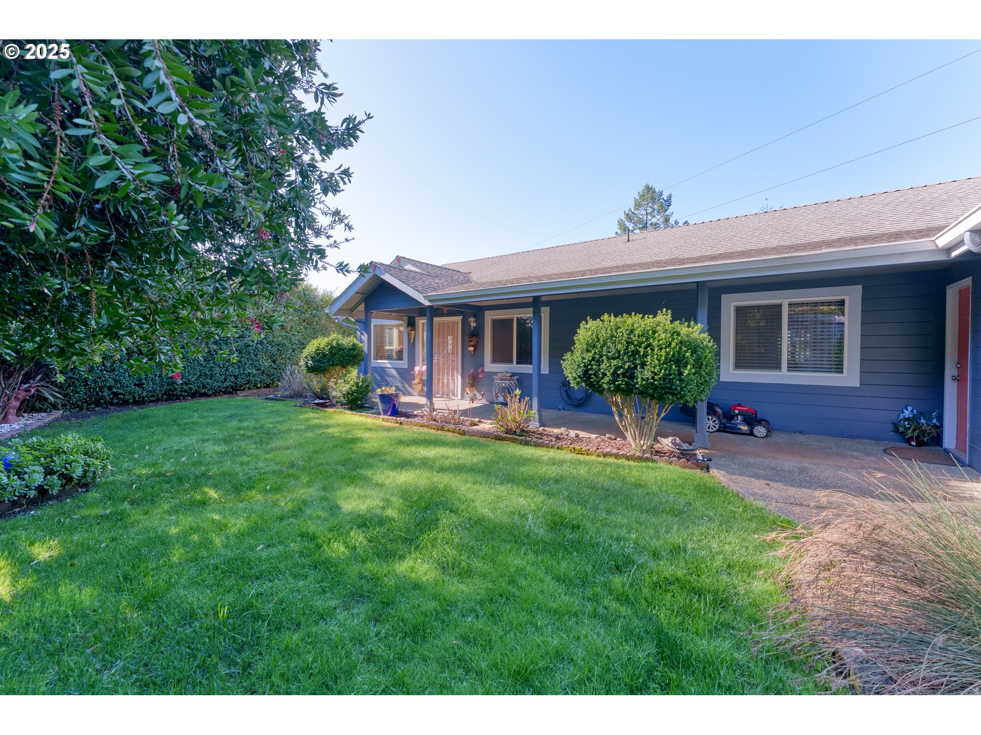 838 Marina Heights Road Brookings, OR 97415 - Photo 9 of 47 a front view of a house with garden