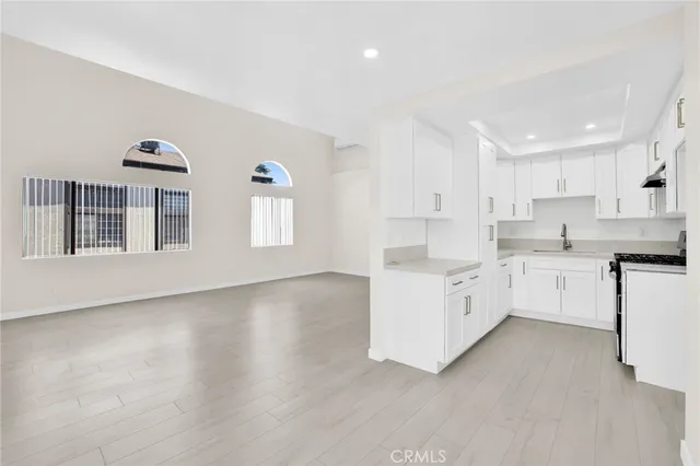 a kitchen with white cabinets and white appliances