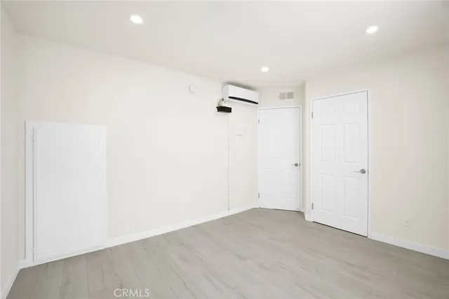 a view of a room with wooden floor