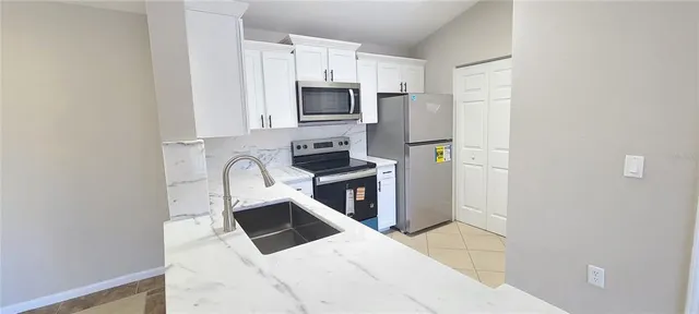 an empty room with closet and mirror