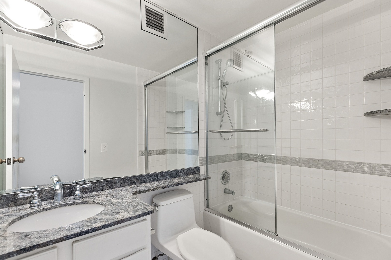 33 West Delaware Place, Unit 22H Chicago, IL 60610 - Photo 13 of 23 a bathroom with a granite countertop sink toilet and shower