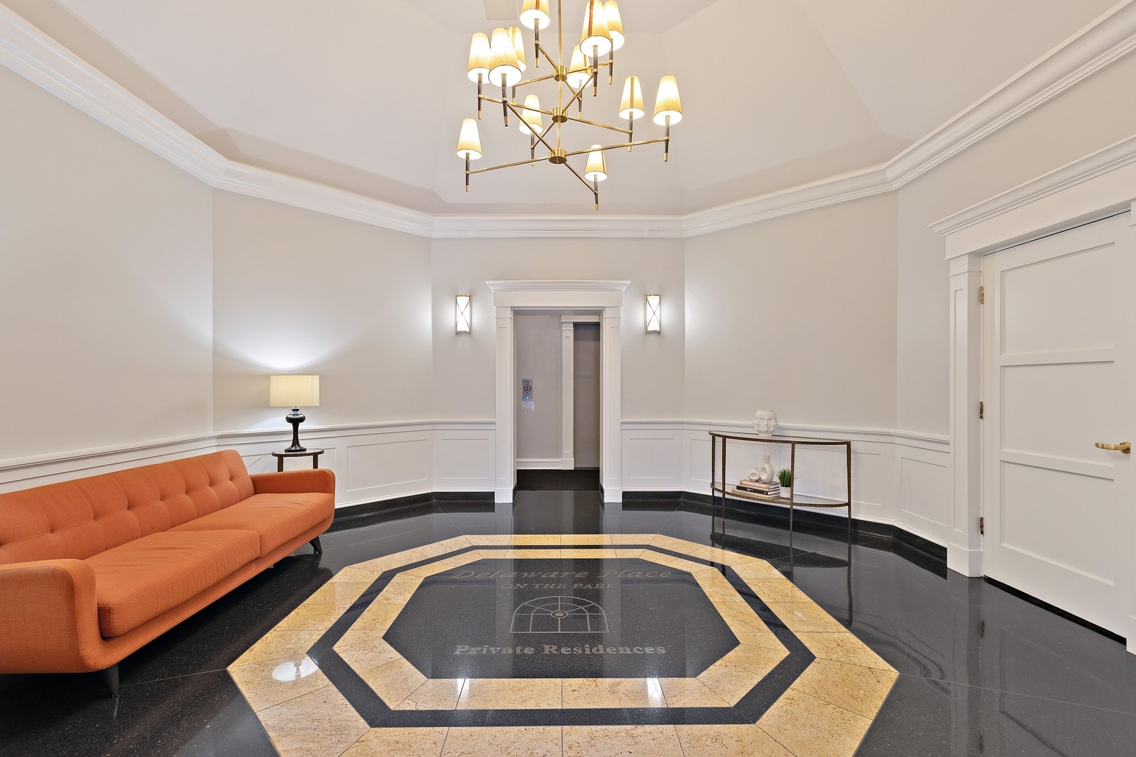 33 West Delaware Place, Unit 22H Chicago, IL 60610 - Photo 2 of 23 a living room with couch and chandelier
