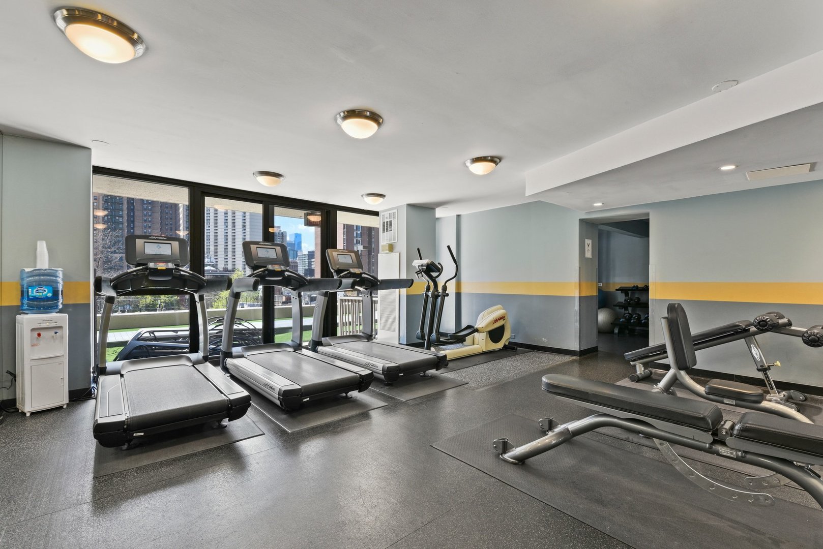 33 West Delaware Place, Unit 22H Chicago, IL 60610 - Photo 21 of 23 a room with gym equipment and glass door