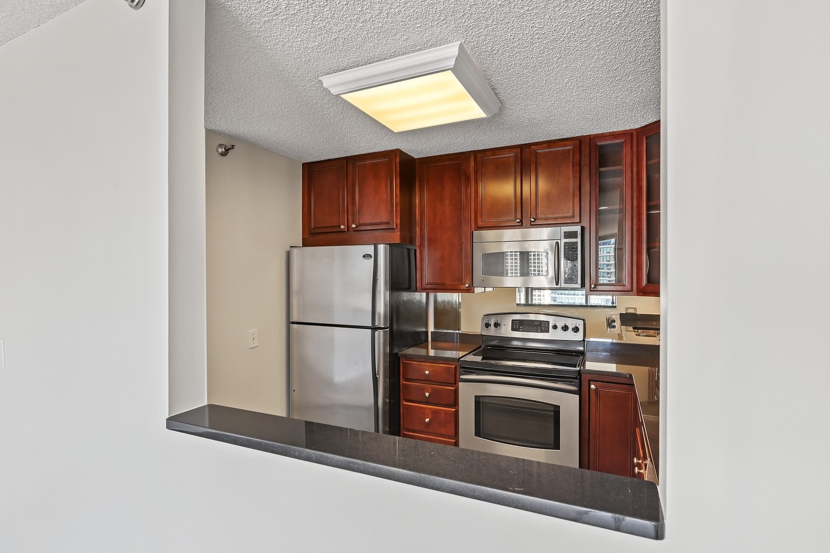 33 West Delaware Place, Unit 22H Chicago, IL 60610 - Photo 4 of 23 a kitchen with a stove and a refrigerator