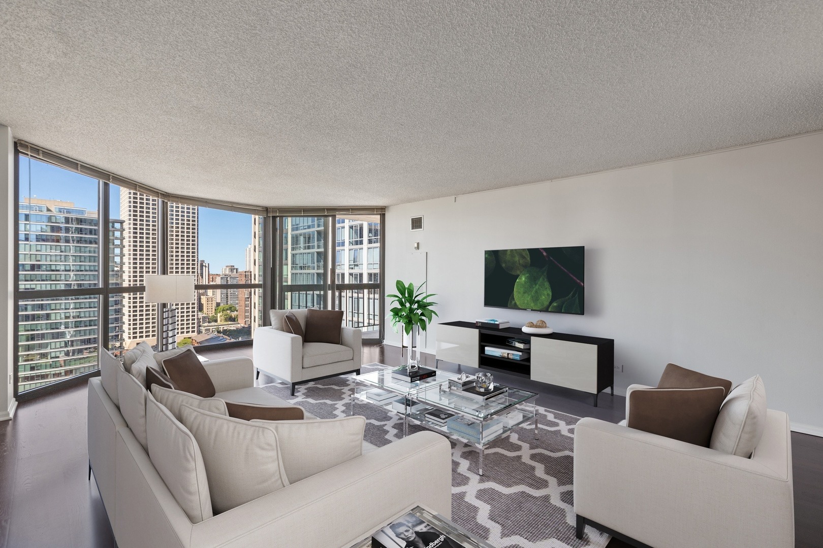 33 West Delaware Place, Unit 22H Chicago, IL 60610 - Photo 5 of 23 a living room with furniture and a flat screen tv