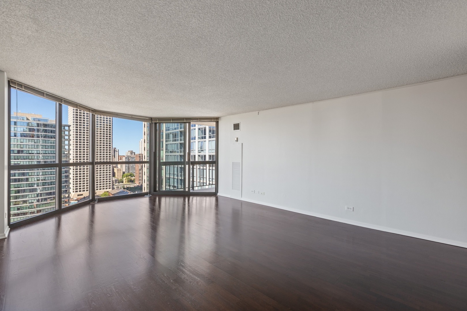 33 West Delaware Place, Unit 22H Chicago, IL 60610 - Photo 6 of 23 a view of an empty room with wooden floor and a window