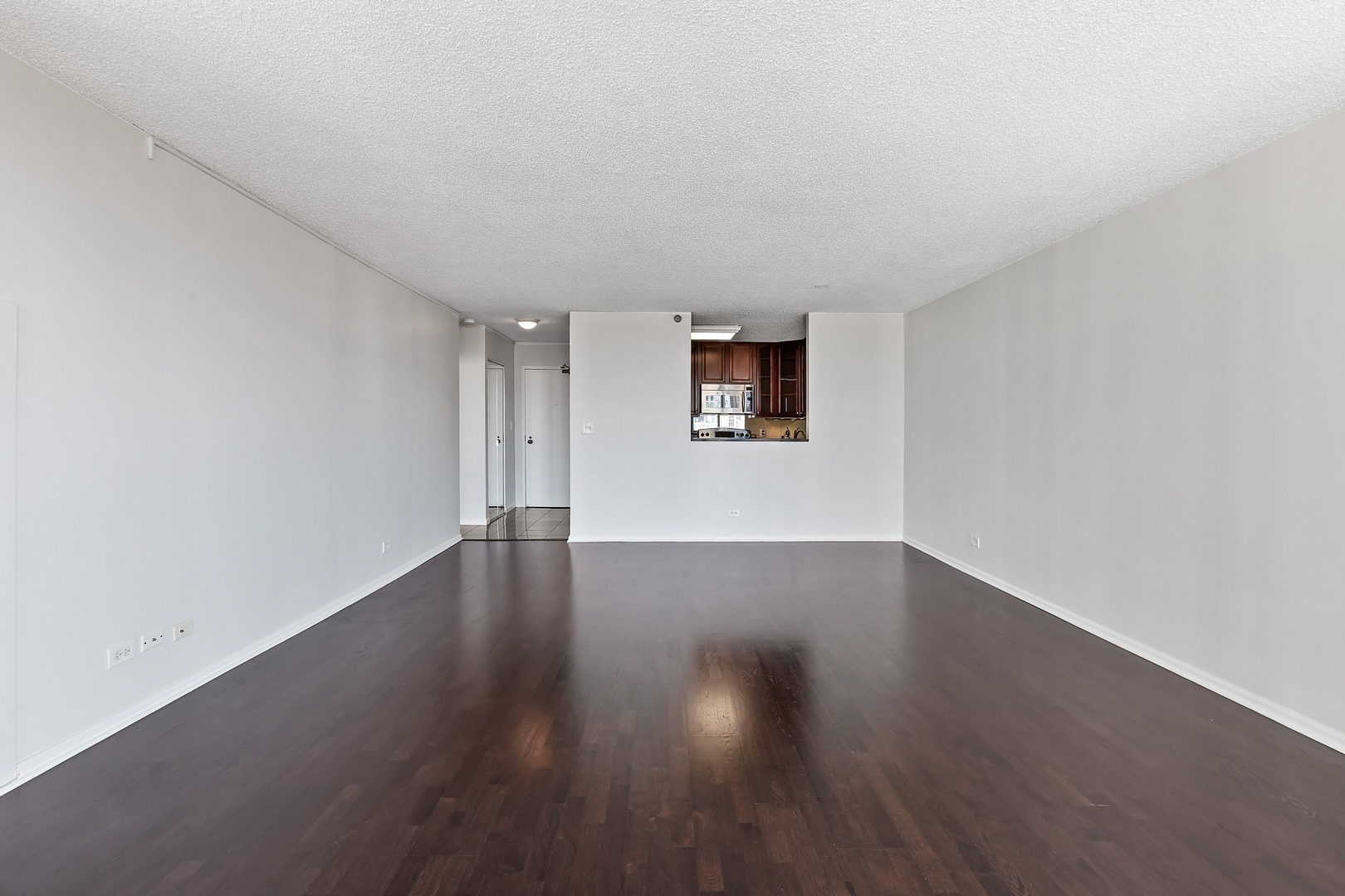33 West Delaware Place, Unit 22H Chicago, IL 60610 - Photo 8 of 23 a view of an empty room with wooden floor and a window