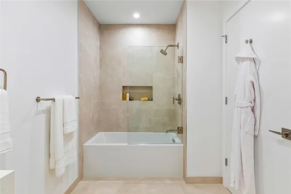 a bathroom with a bathtub and shower