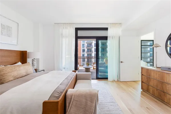 a bedroom with a large bed and a dresser