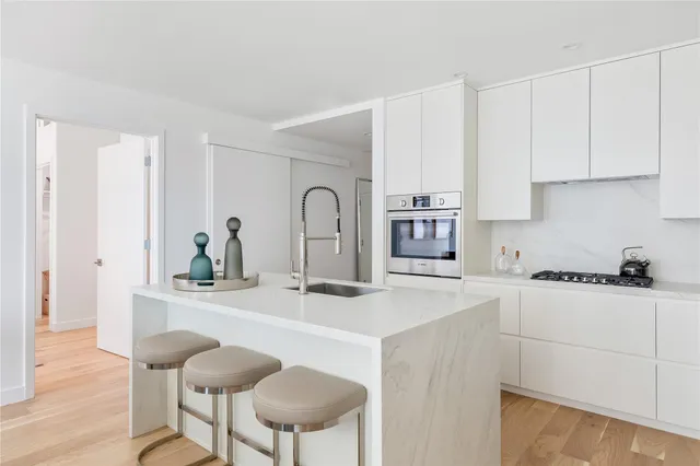 a kitchen with stainless steel appliances a sink and cabinets