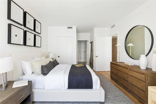 a bedroom with a bed and a mirror