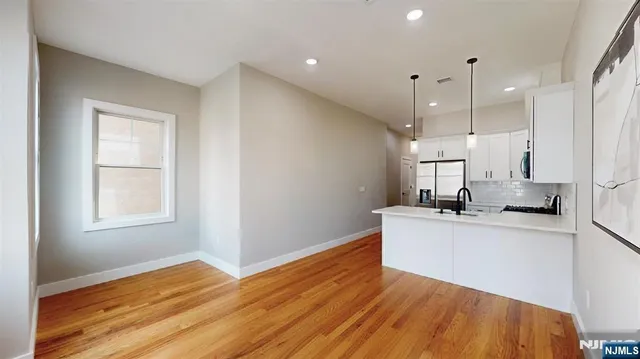 a view of a kitchen with wooden floor