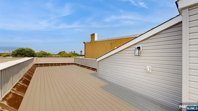 a view of a balcony with wooden floor and city view