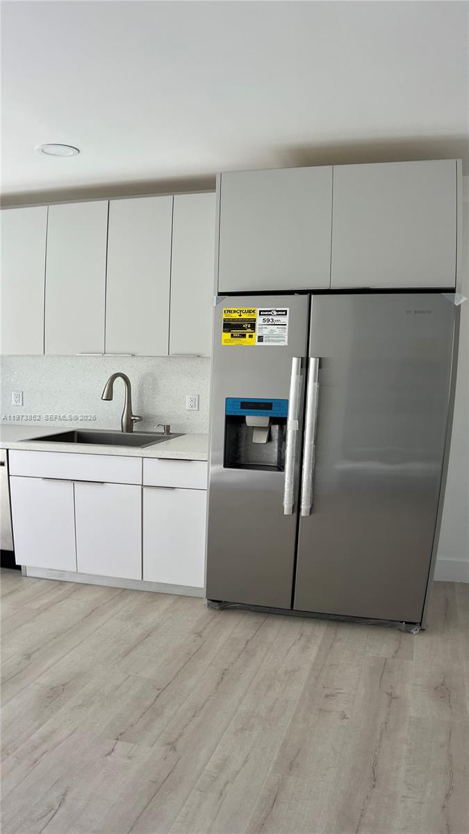 2800 Southwest 25th Street, Unit 1 Miami, FL 33133 - Photo 11 of 48 a kitchen with a sink and a refrigerator
