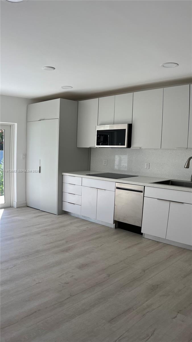 2800 Southwest 25th Street, Unit 1 Miami, FL 33133 - Photo 12 of 48 a view of a kitchen with a sink and a refrigerator