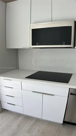 a kitchen with a stove and a refrigerator