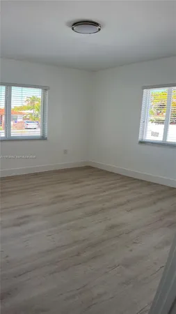 a view of room with stairs and wooden floor
