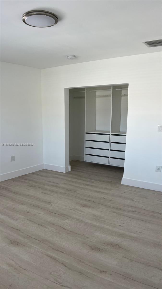 2800 Southwest 25th Street, Unit 1 Miami, FL 33133 - Photo 22 of 48 a view of wooden floor and windows in a room