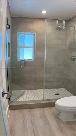 a bathroom with a toilet and a shower