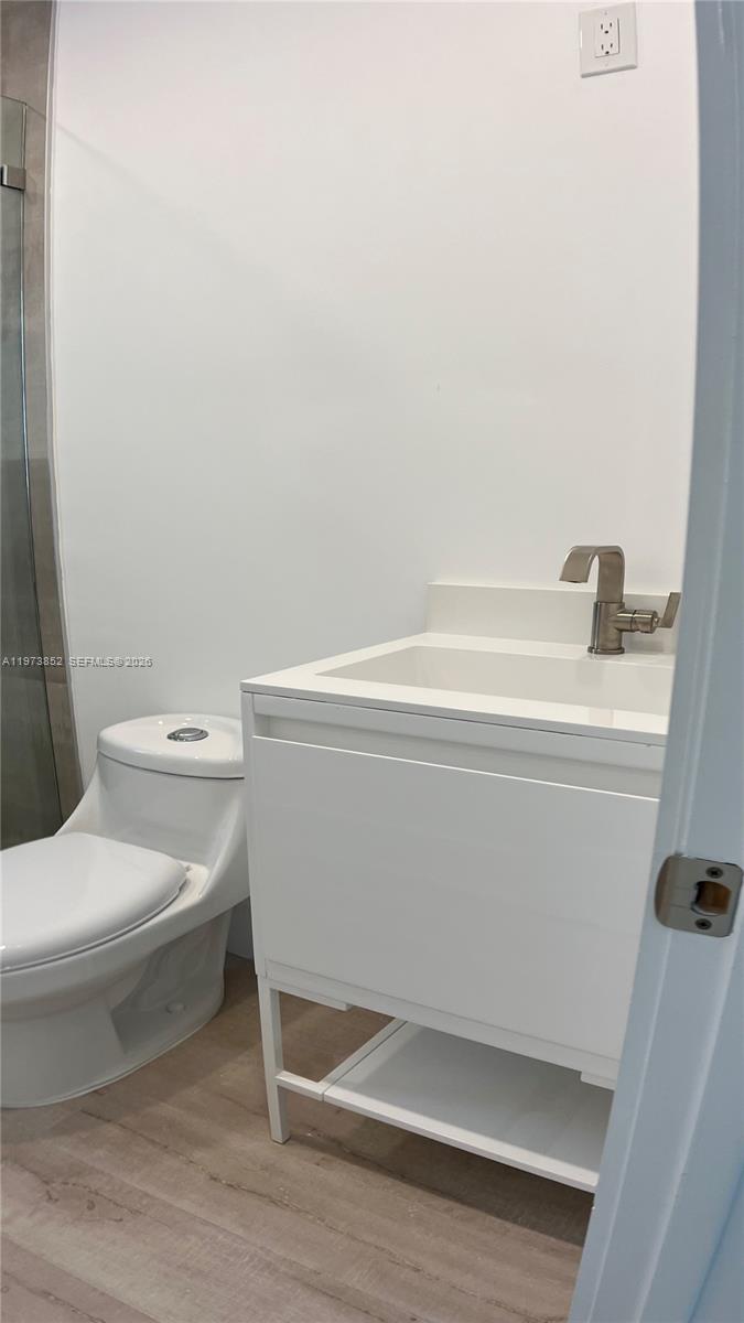 2800 Southwest 25th Street, Unit 1 Miami, FL 33133 - Photo 27 of 48 a bathroom with a toilet and a sink